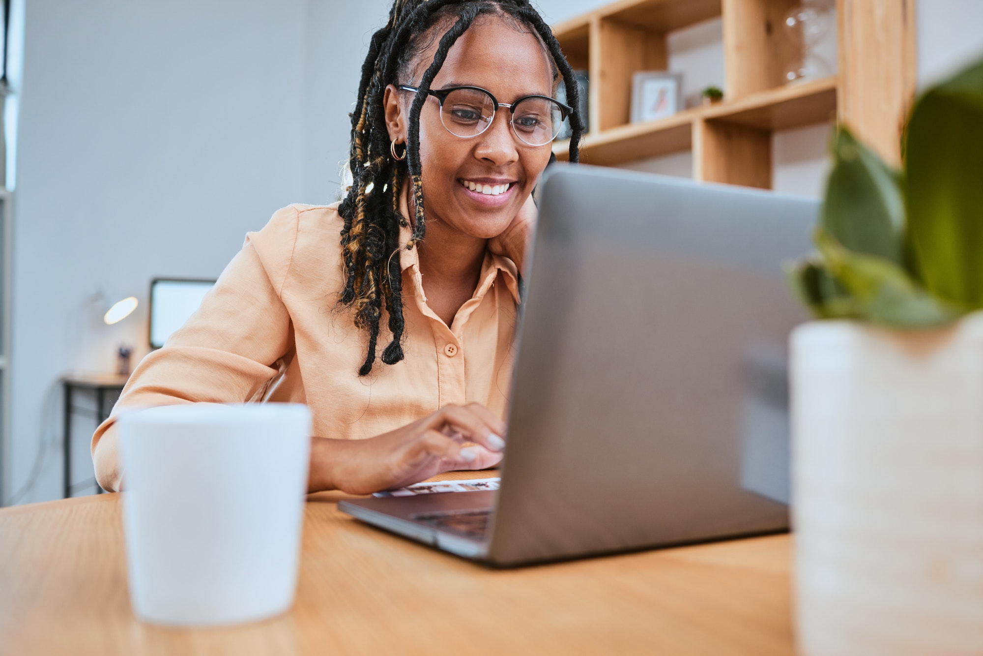 Laptop, research and report with a freelance black woman doing remote work online from her home off